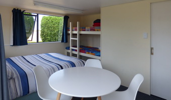 Studio interior showing double bed bunks and table